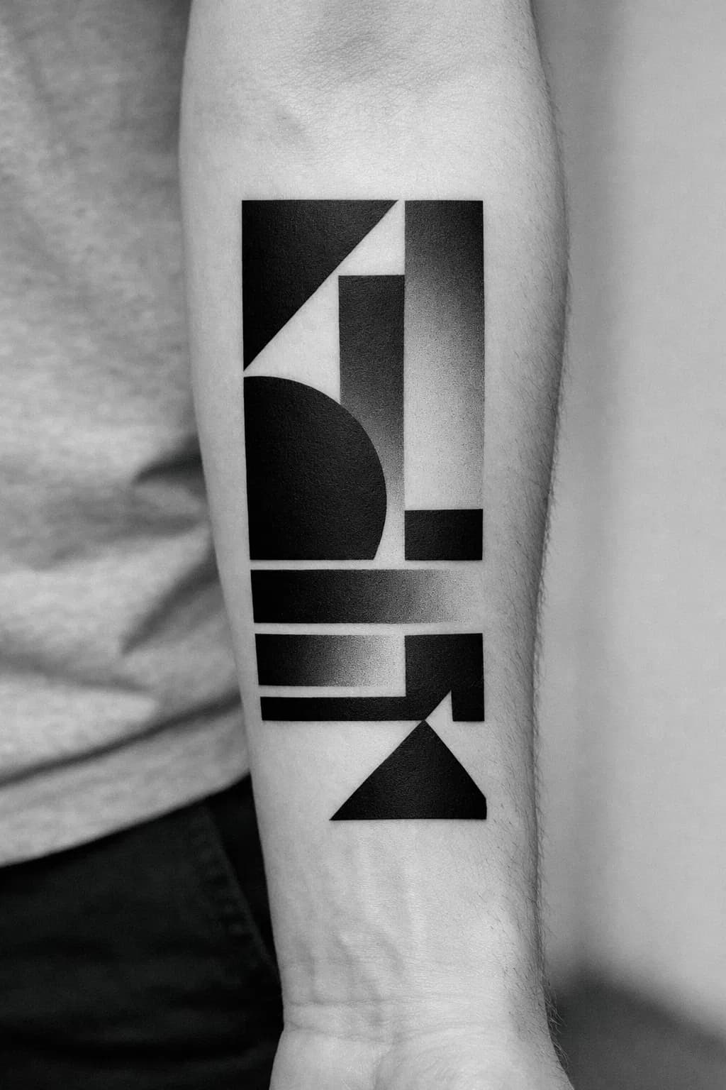 Geometric blackout panel cover-up tattoo with abstract shapes